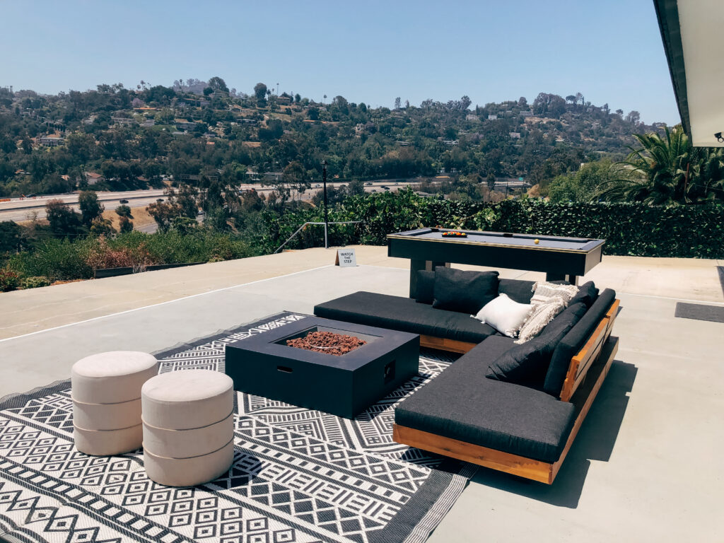 large outdoor sectional with fire pit at the backyard of the murray house vacation rental san diego